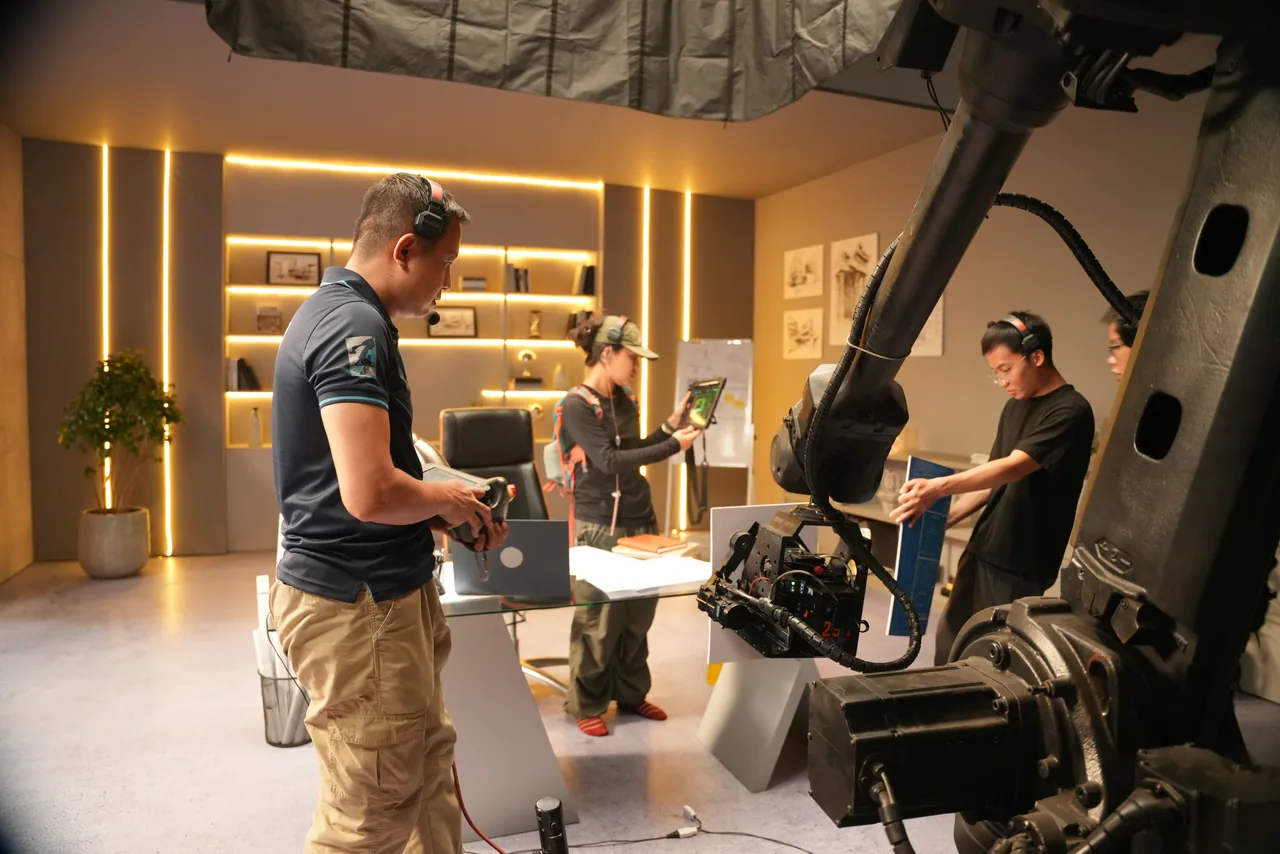 The crew grouped under the arm on a warm shelf-lit apartment set
