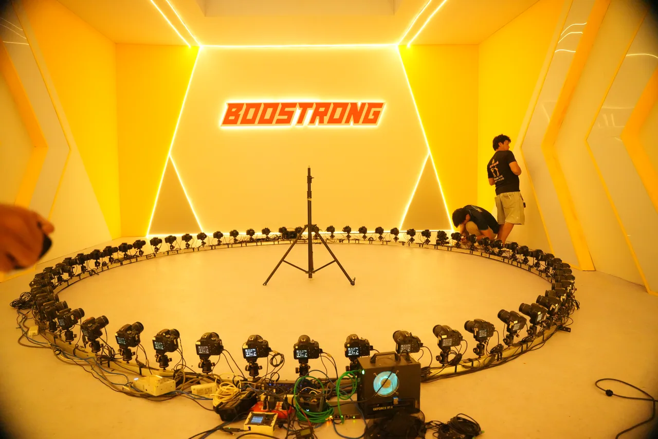 A circular multi-camera array ringing a set under warm amber light for a frozen-moment shot