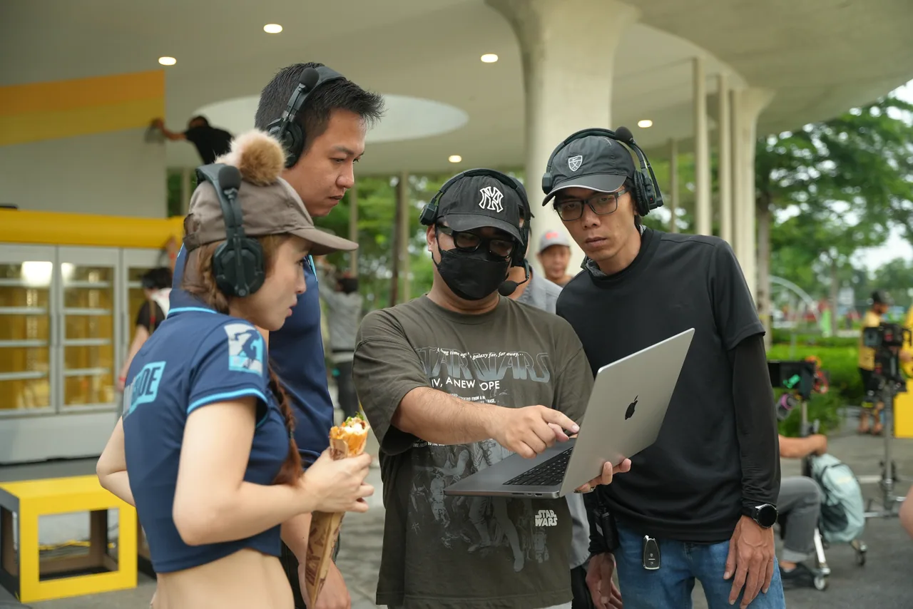 The LumiGrade crew huddled around a laptop between set-ups on a location shoot