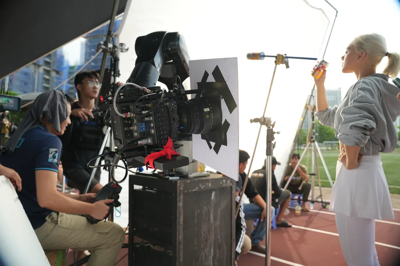 The camera set low on the running track while the athlete waits on her mark